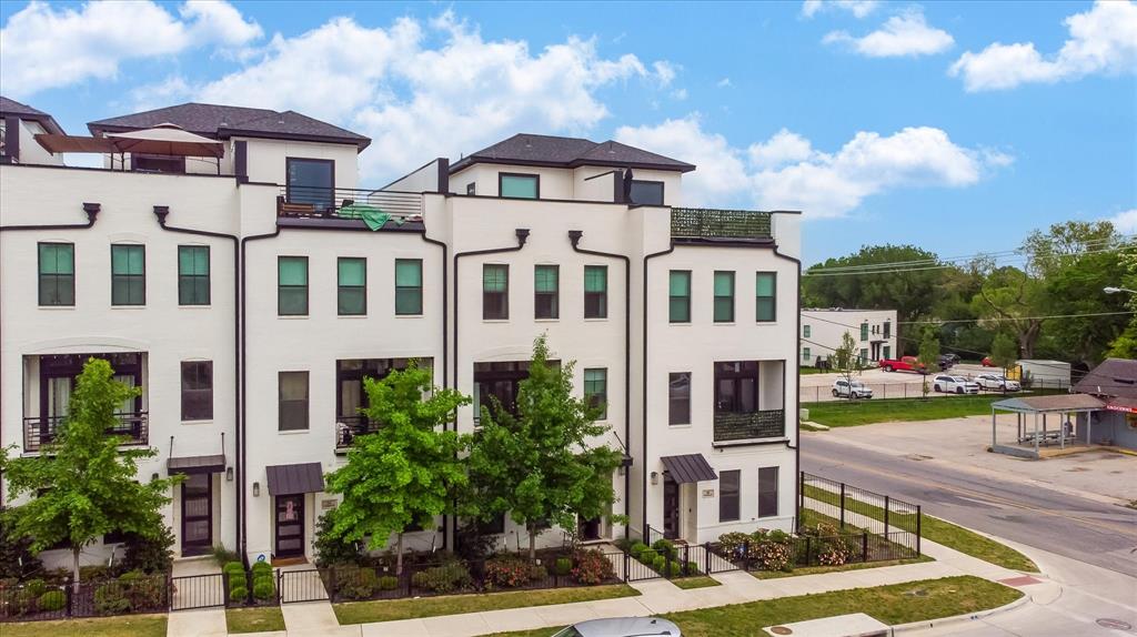 a front view of a residential apartment building with a yard