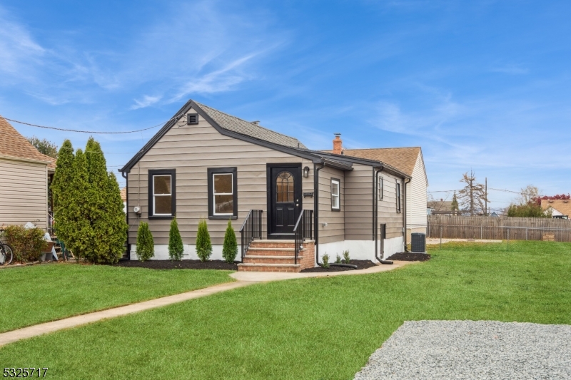 a view of a house with a yard and a garden