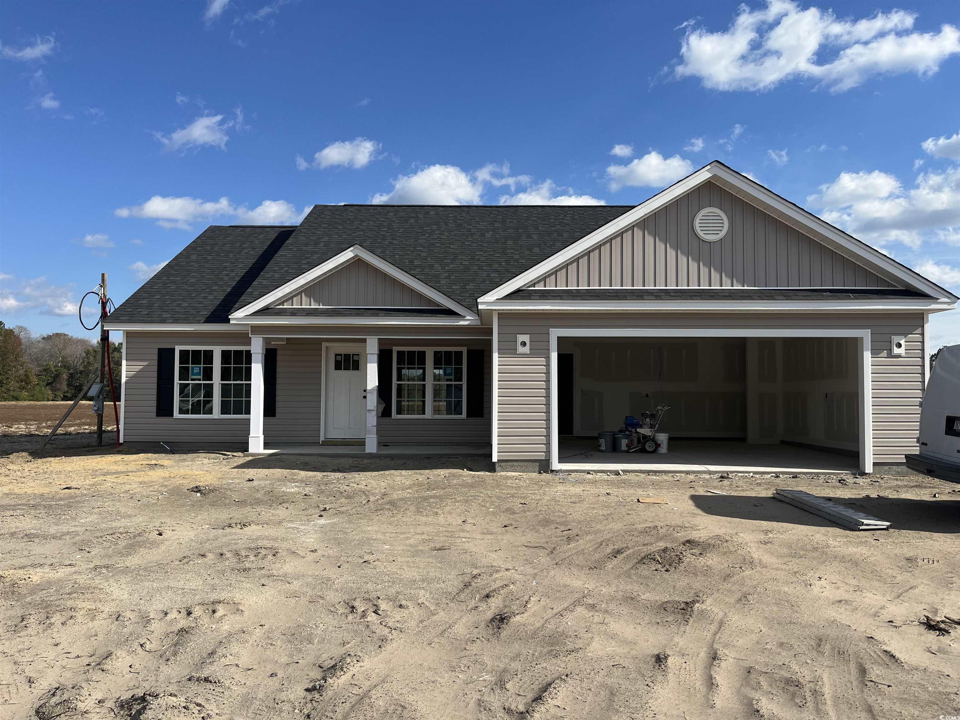 View of front of property with a porch and a garag