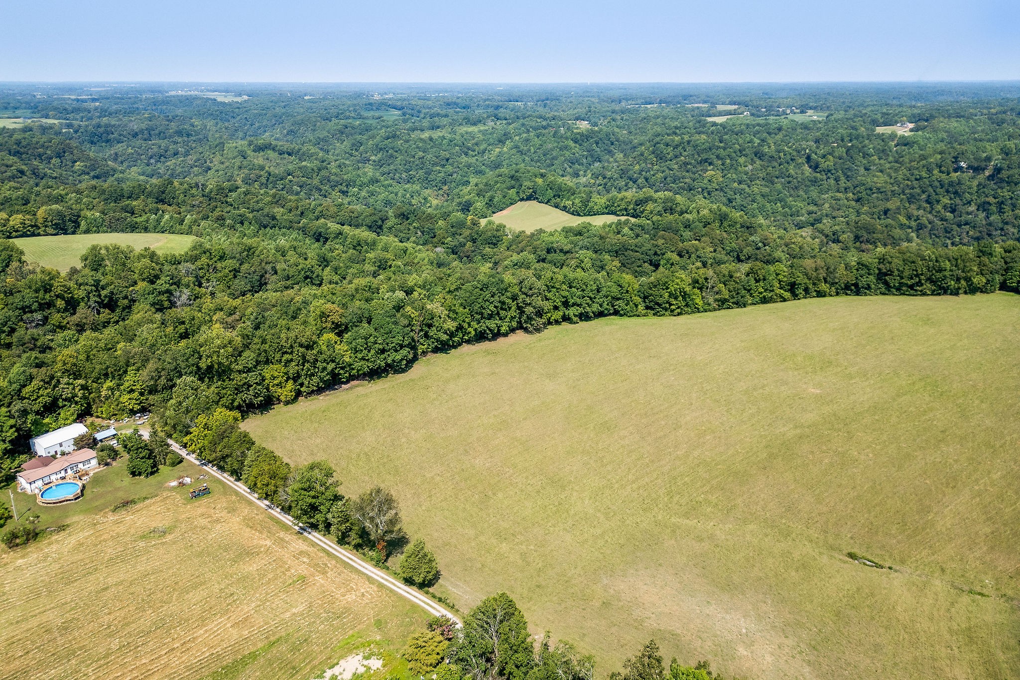 a view of a large yard with lots of green space