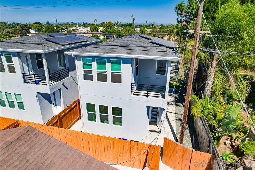 a view of a house with a backyard