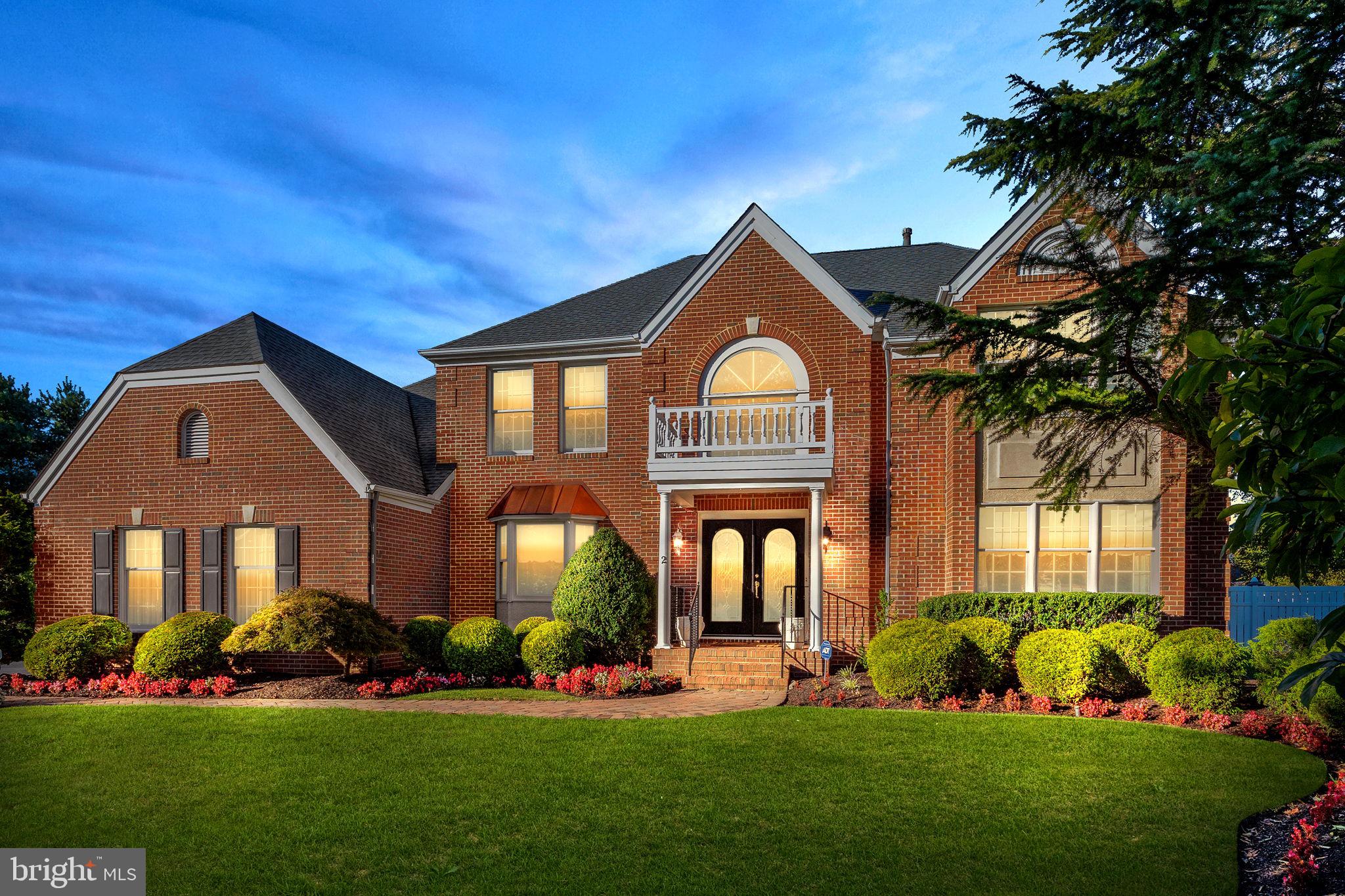 a front view of a house with a garden and plants