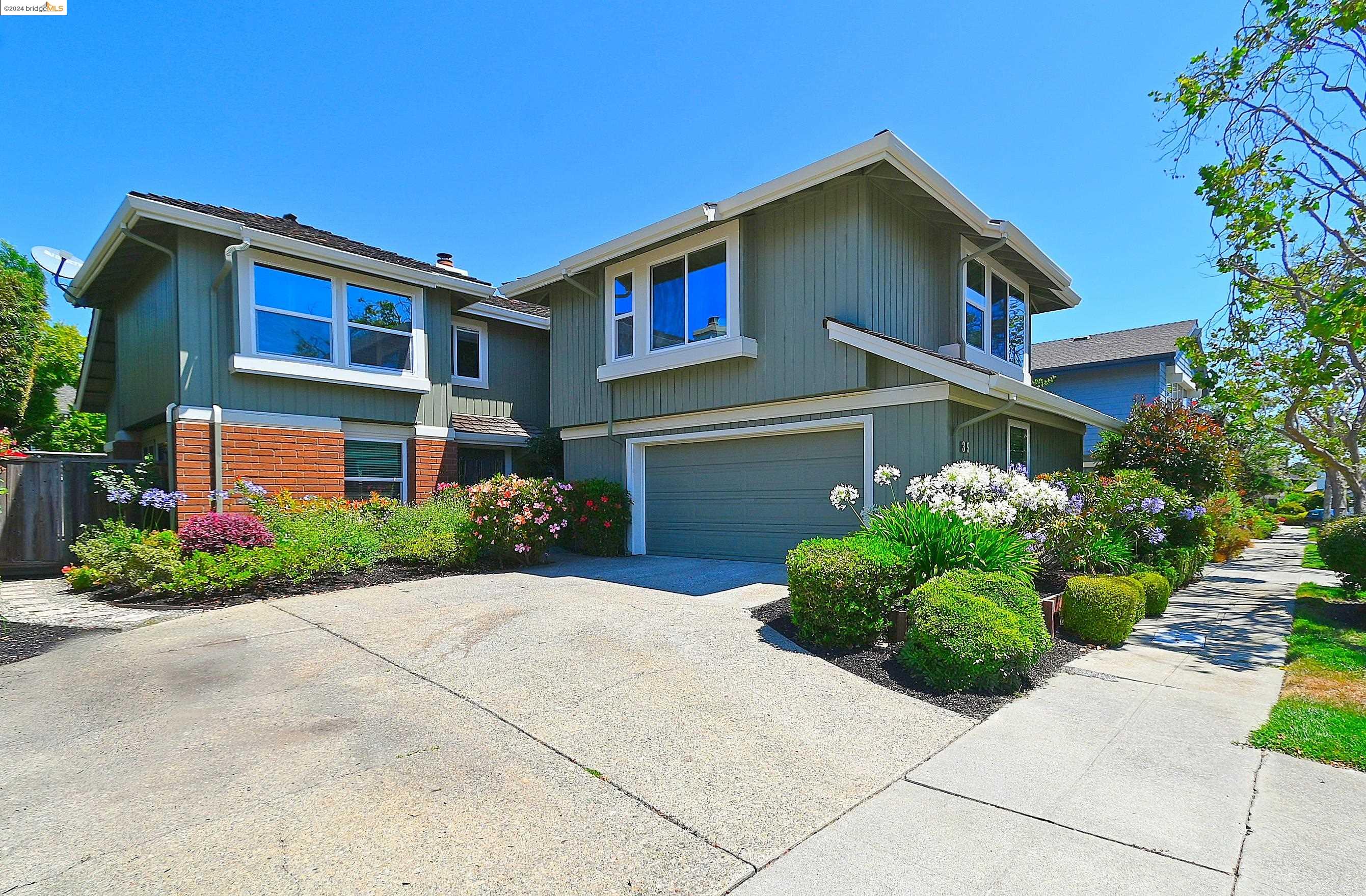 a front view of a house with a garden