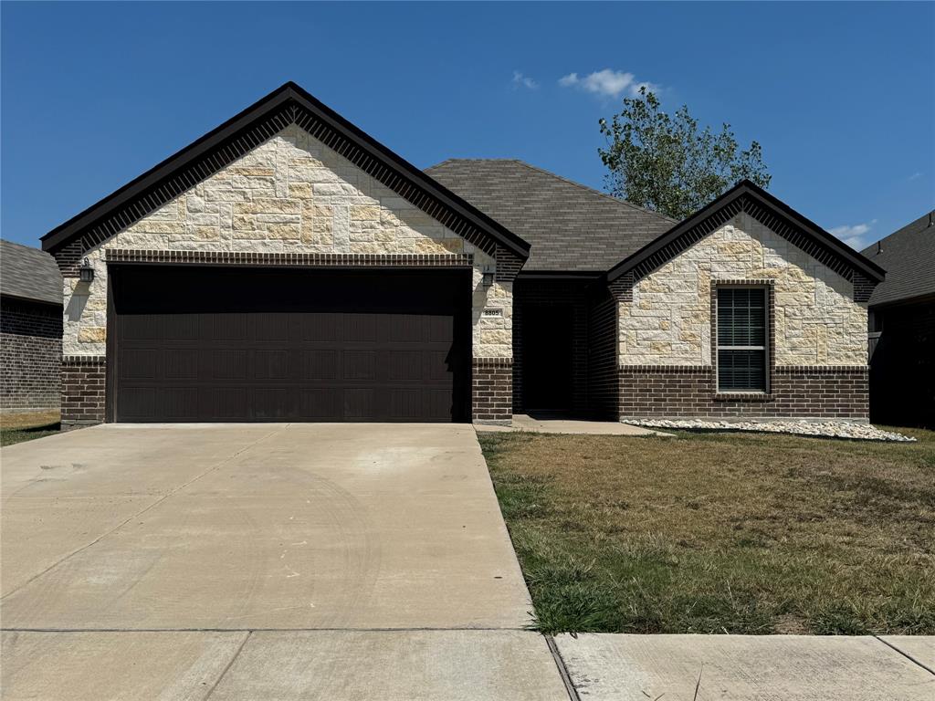 a front view of a house with garage