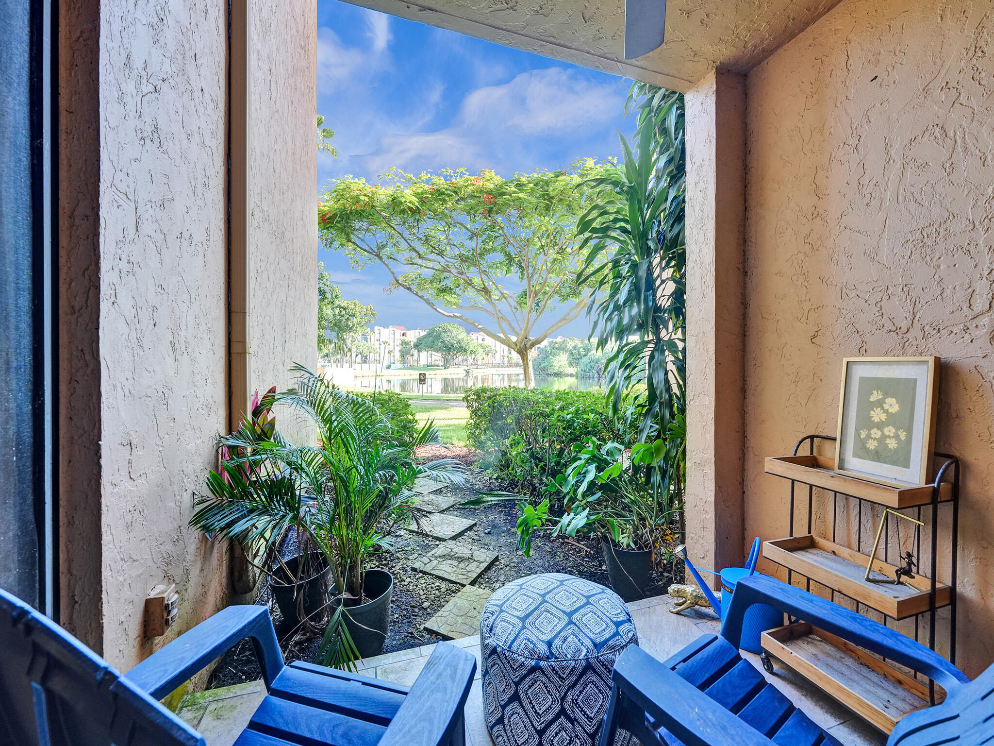 a outdoor living room with furniture and a potted plant