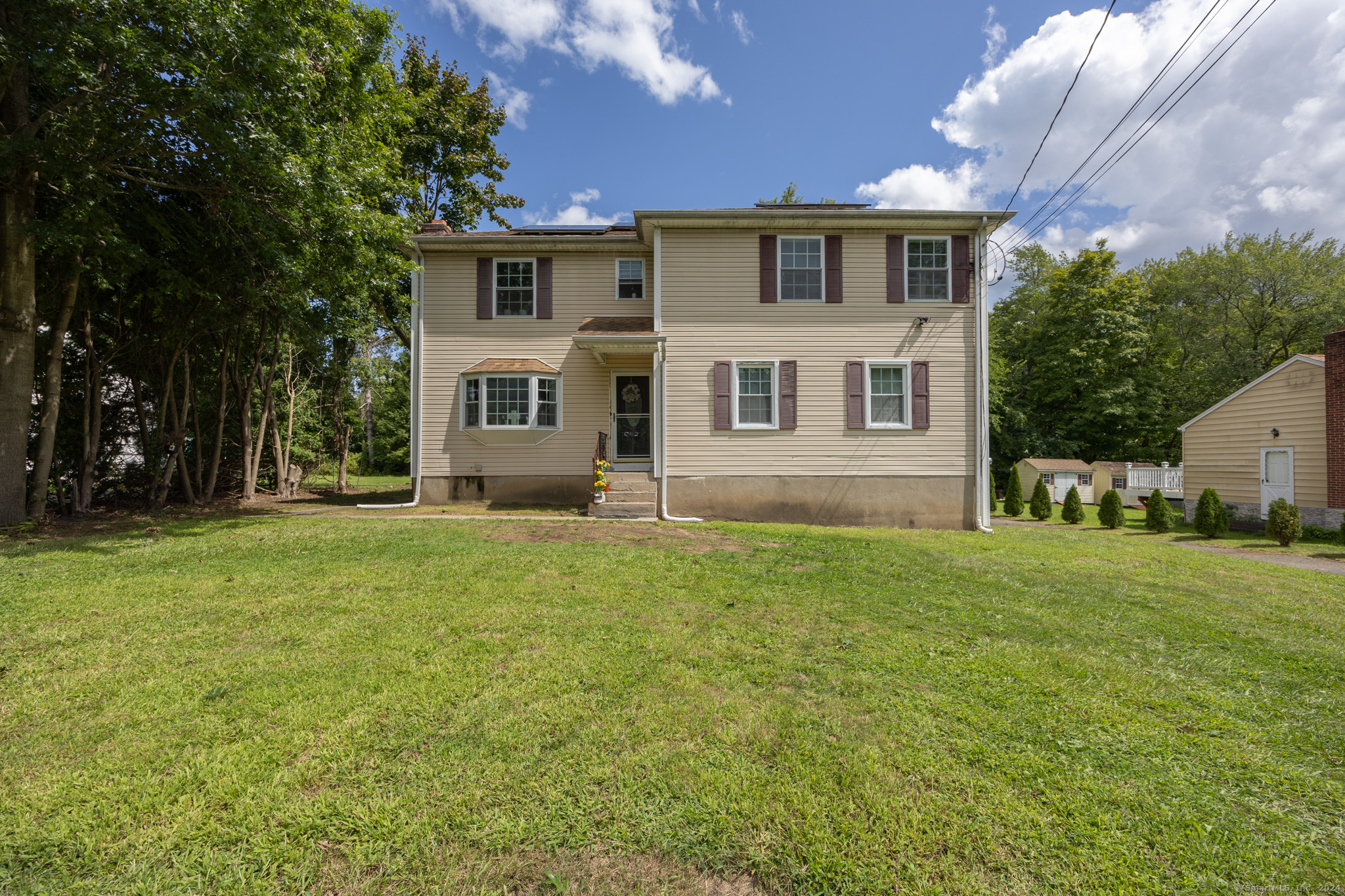 a front view of a house with a yard