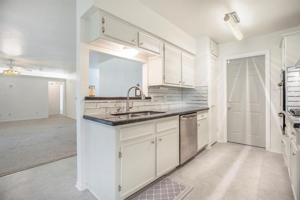 a kitchen with stainless steel appliances granite countertop a sink and cabinets