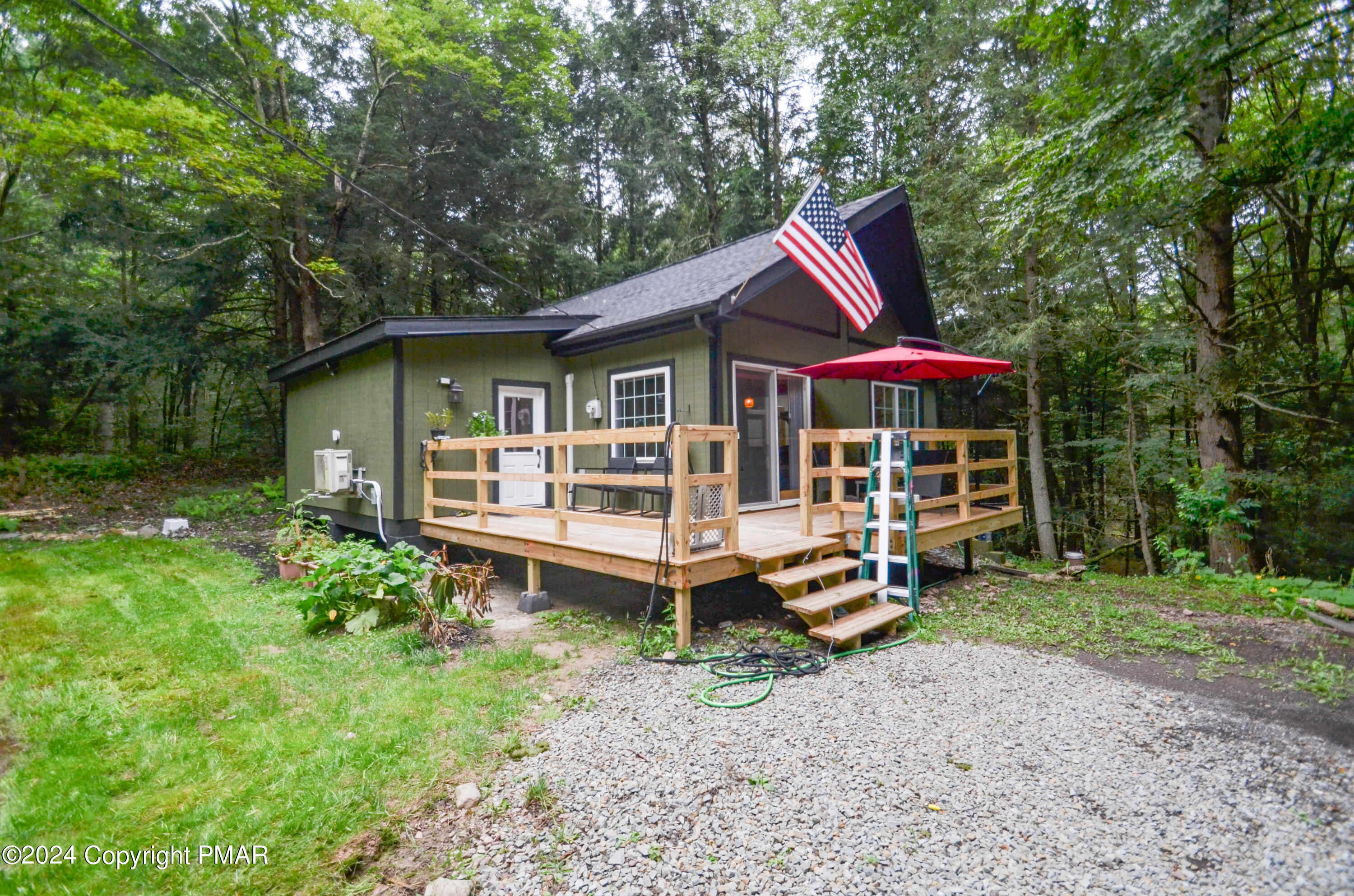 a view of a house with a yard and sitting area