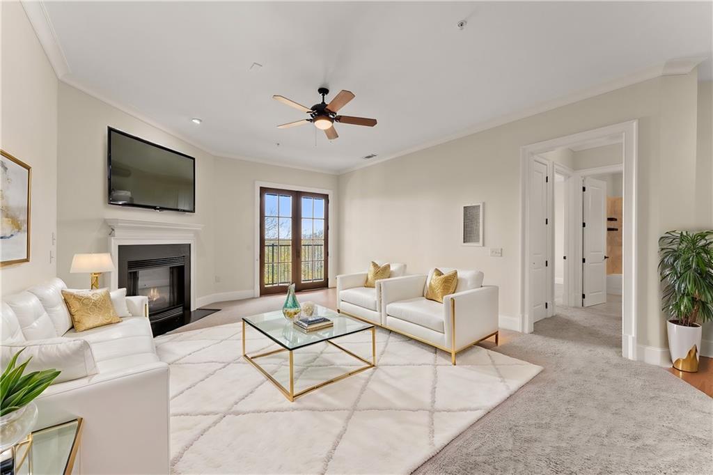 a living room with furniture a fireplace and a flat screen tv