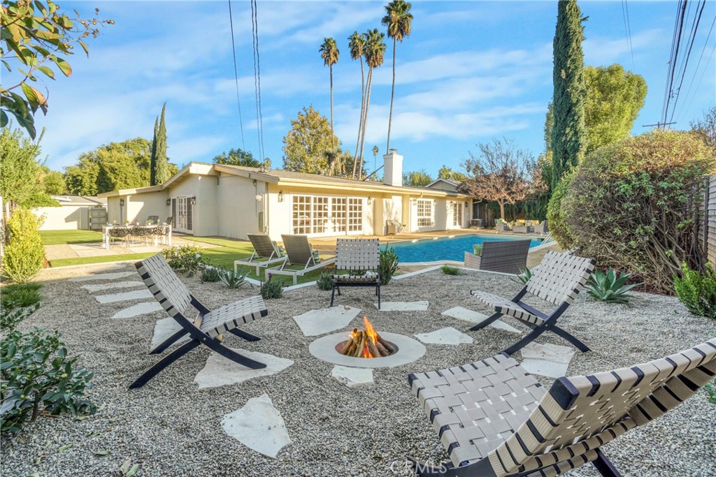 a backyard of a house with table and chairs