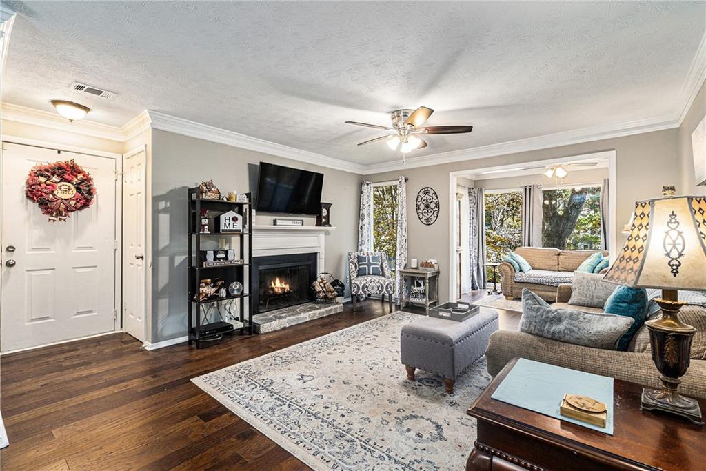 a living room with furniture fireplace and flat screen tv