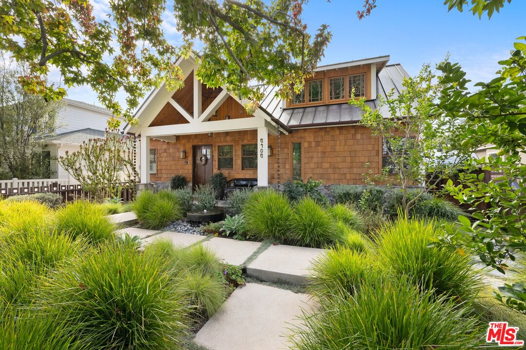 a front view of house with yard and swimming pool