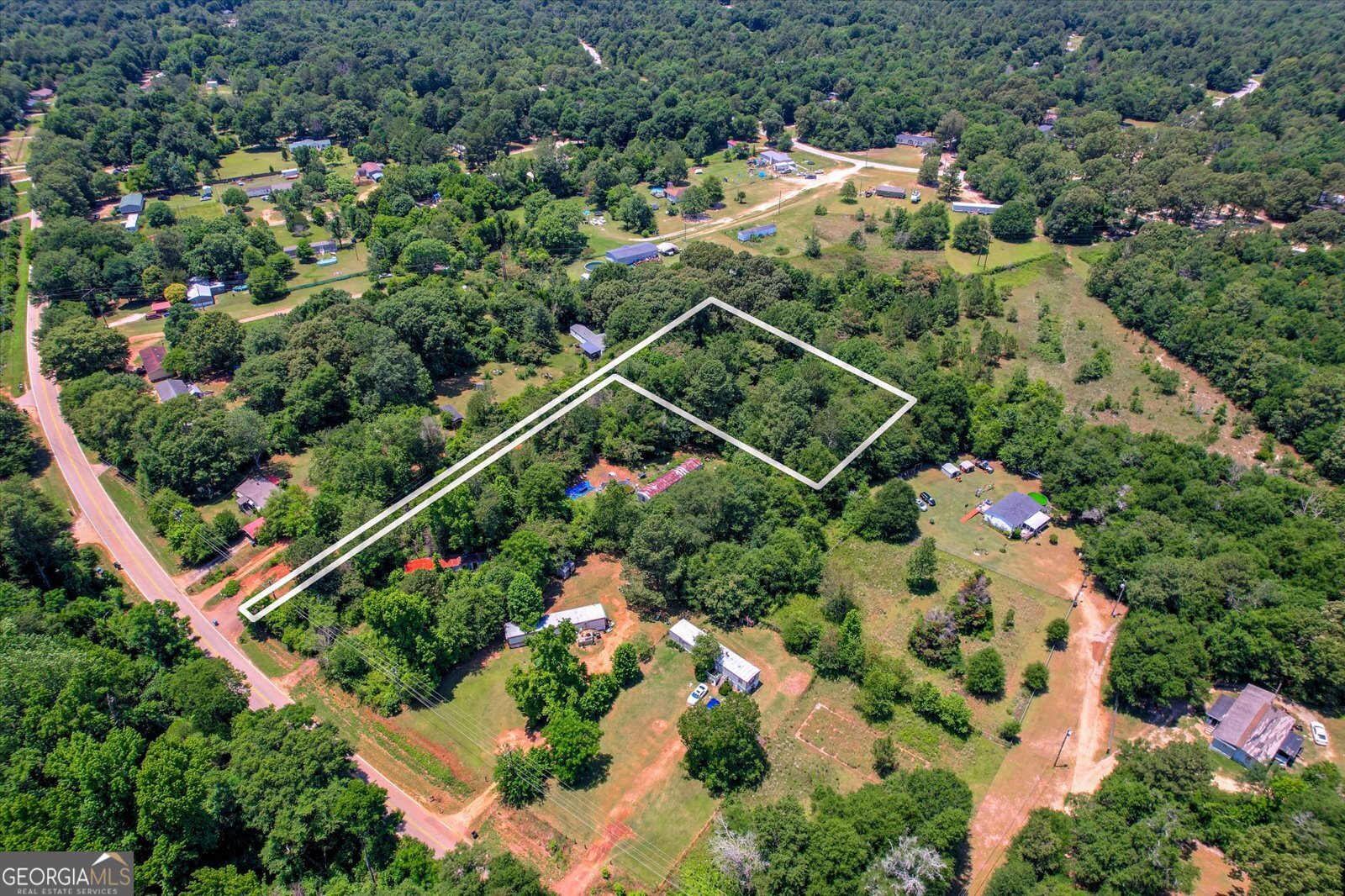 an aerial view of house with swimming pool outdoor seating and yard