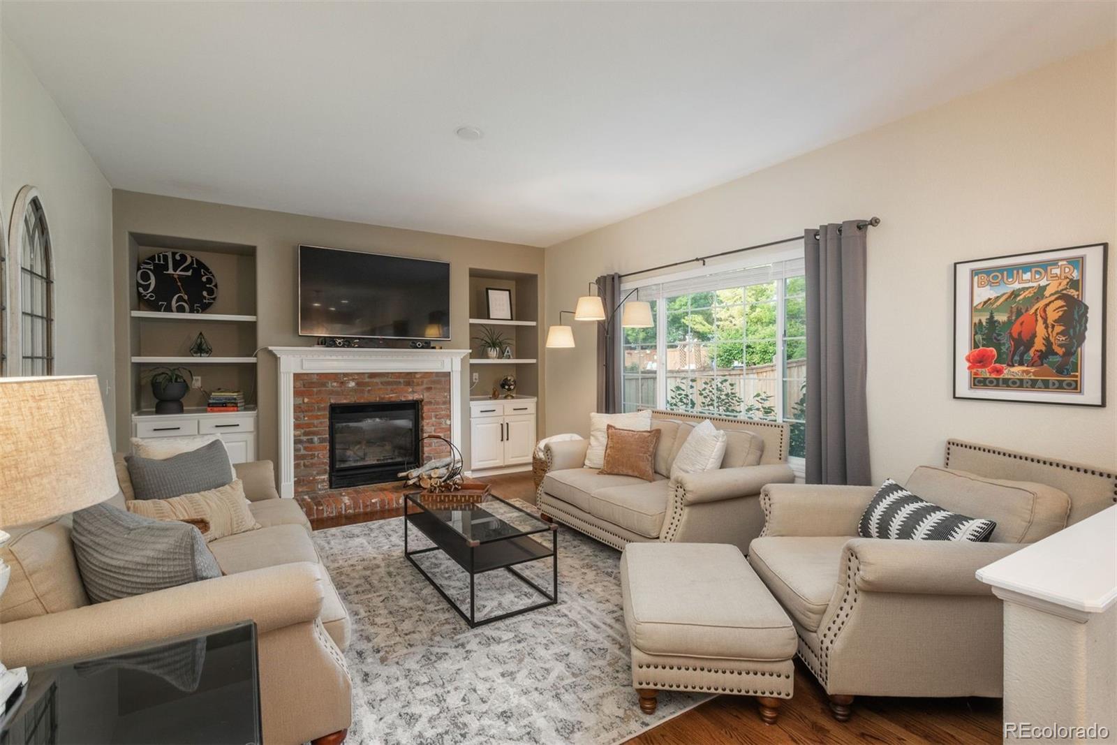 a living room with furniture fireplace and a flat screen tv