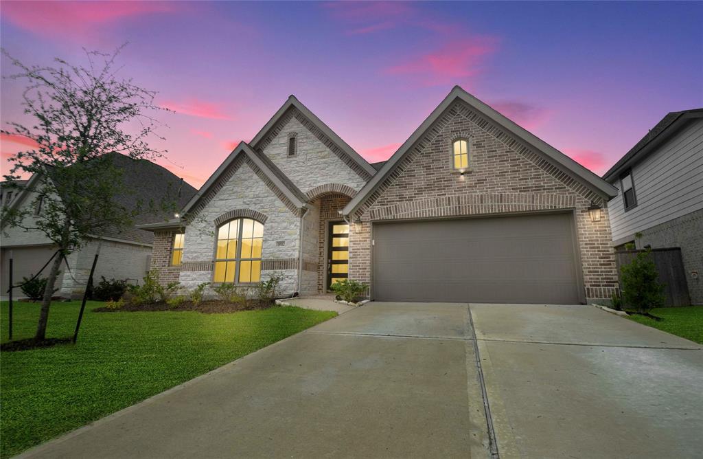 a front view of a house with a yard and garage