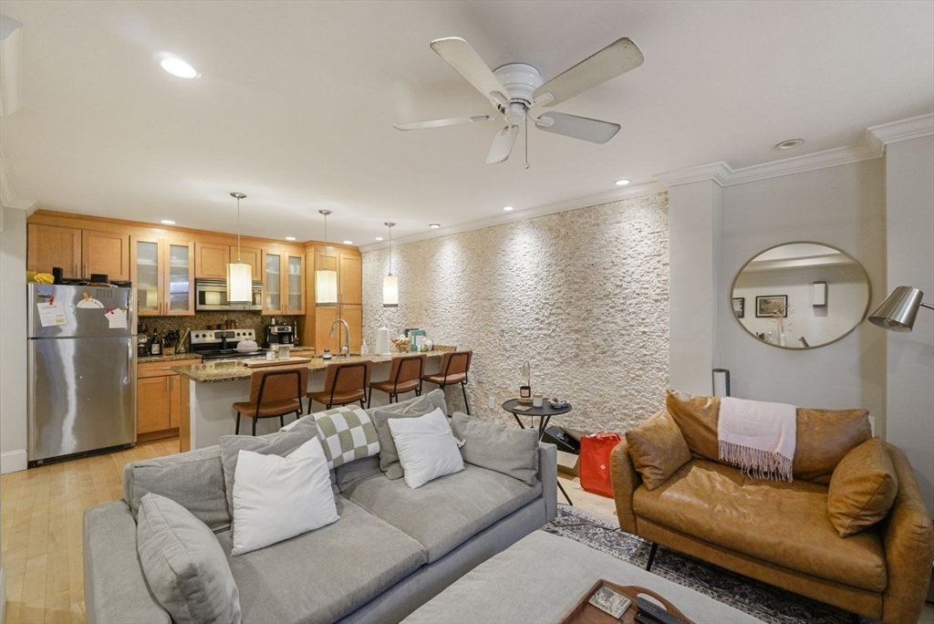 a living room with furniture and kitchen view