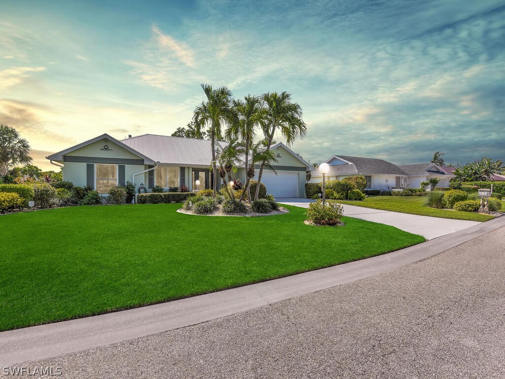 a front view of house with yard and green space