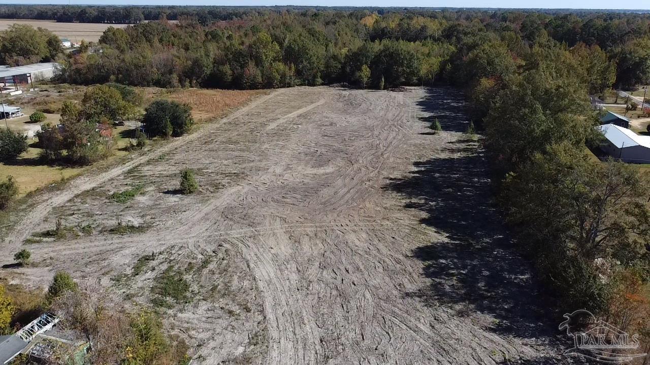 a view of dirt field with trees