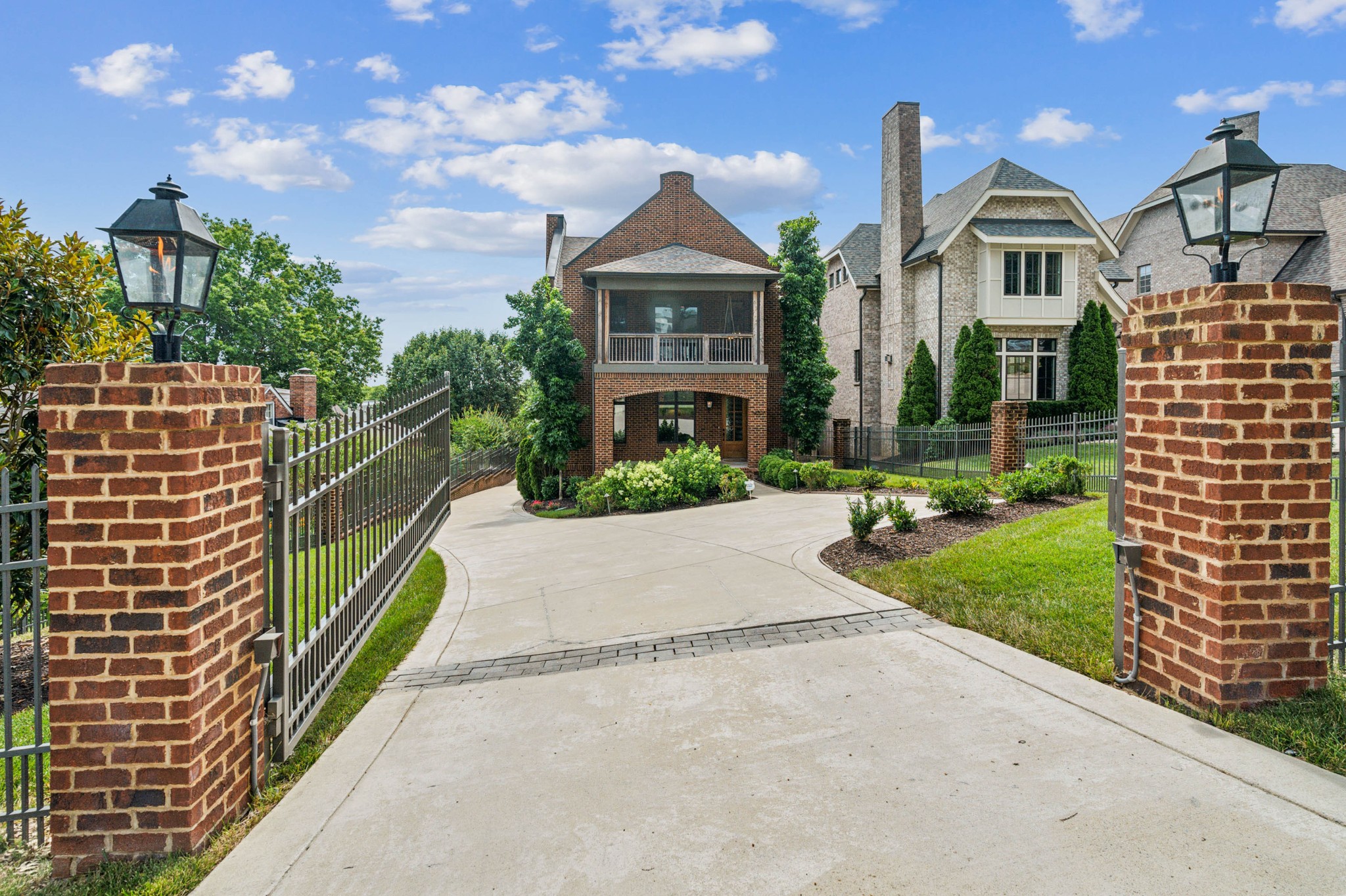 a front view of a house with a yard and potted plants