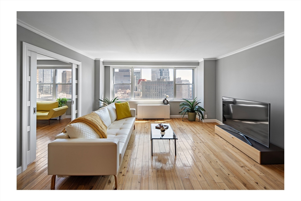 a living room with furniture and a flat screen tv