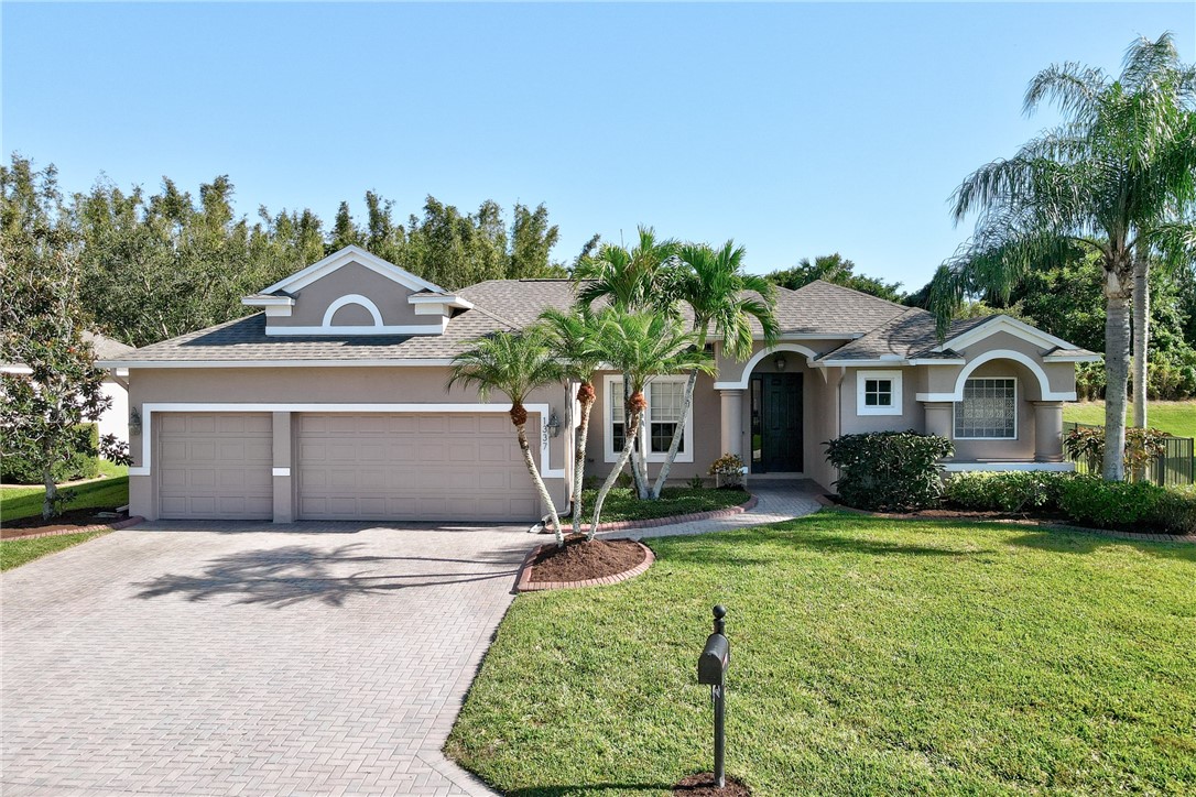 a front view of a house with a yard and garage