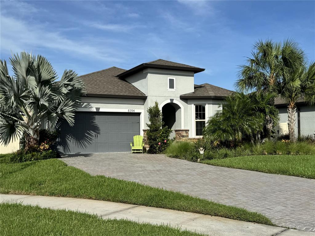 a front view of a house with a yard and garage