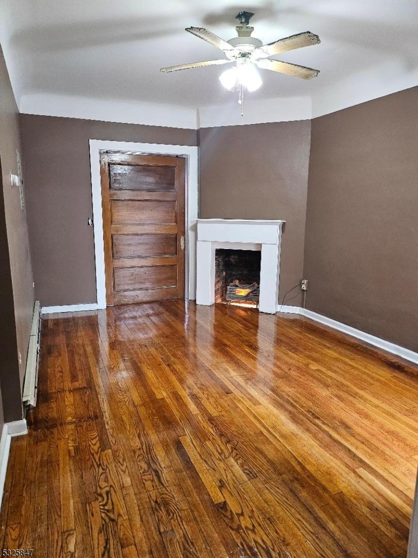 wooden floor fireplace and natural light in room