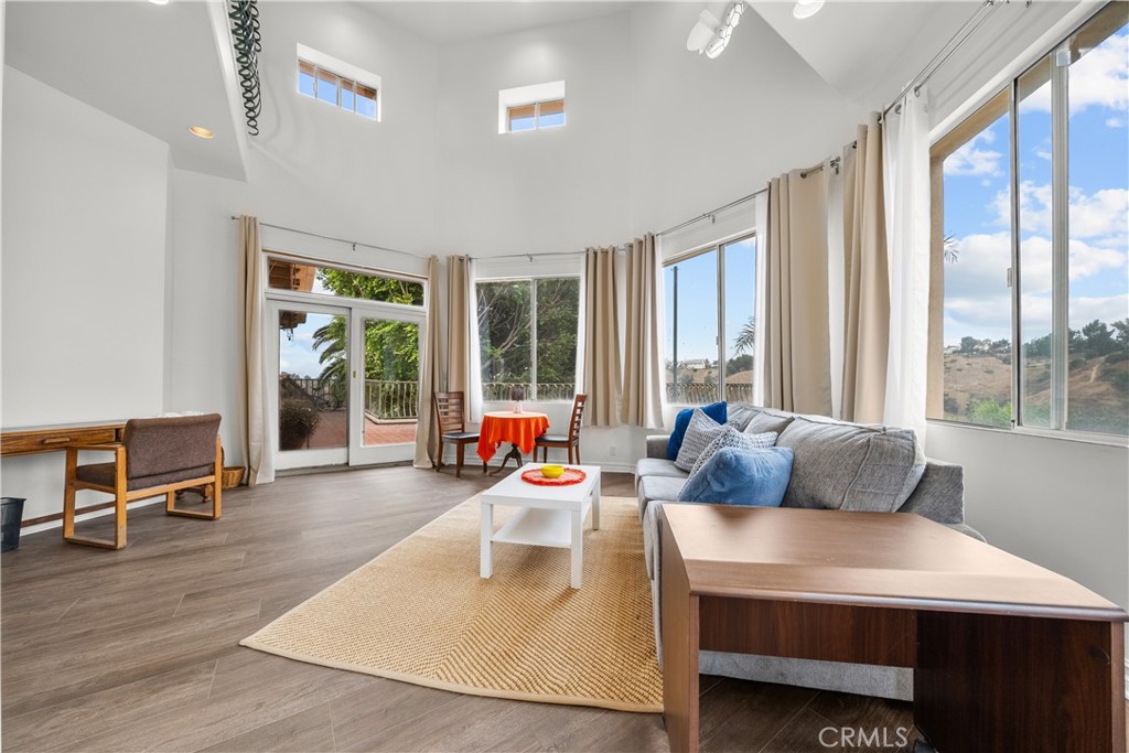 a living room with furniture and large windows