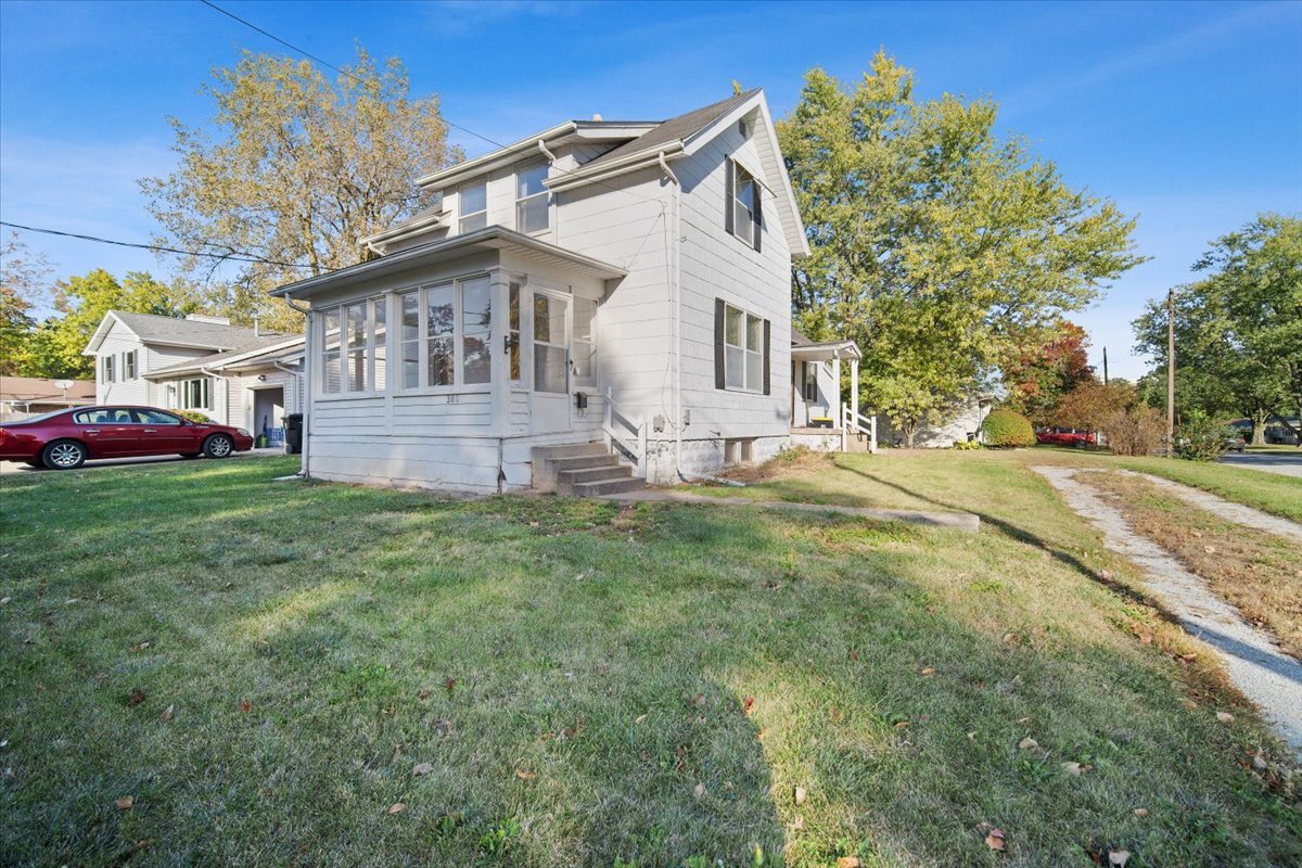 a front view of house with yard and green space