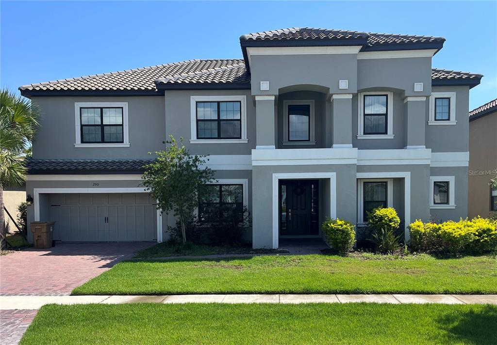 a front view of a house with a garden and yard