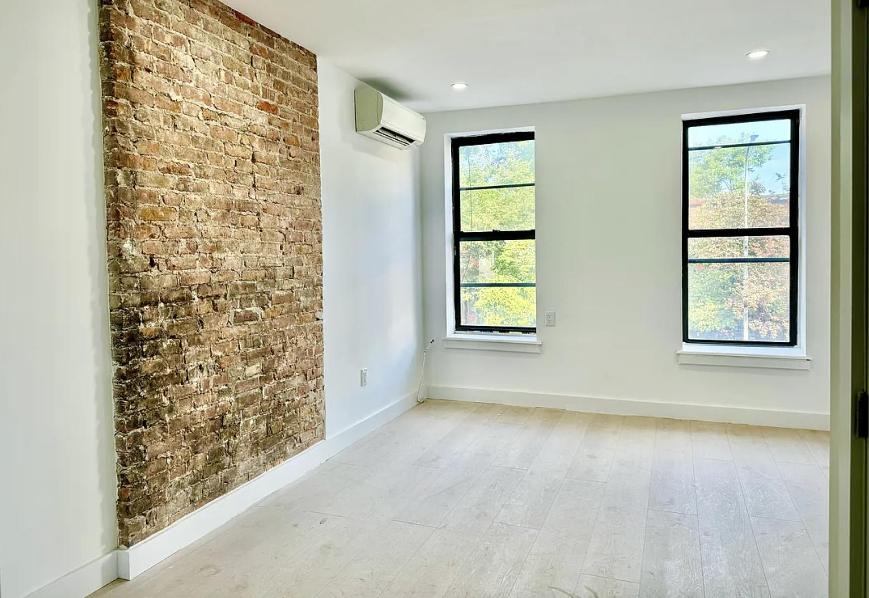 an empty room with windows and closet