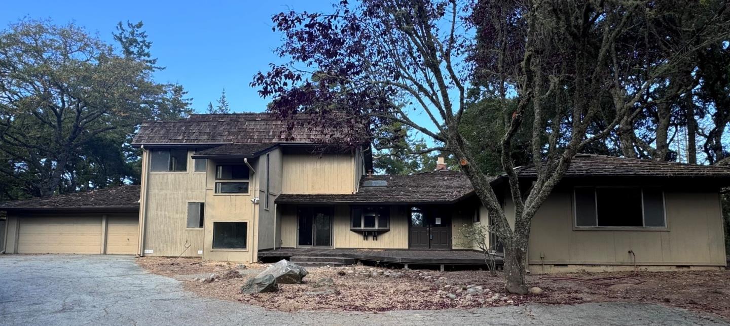 a view of a house with a tree in the background