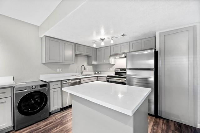 a kitchen with a sink a stove and refrigerator