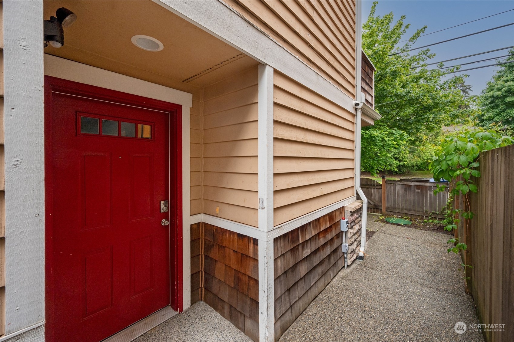 a view of a house with a door and a tree