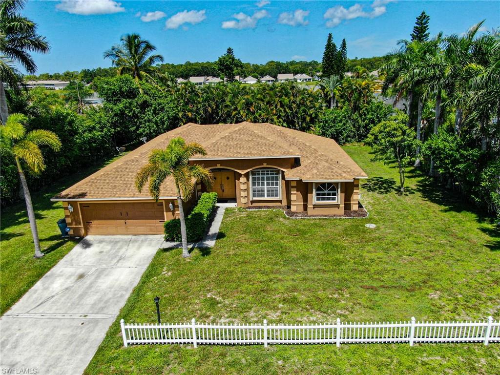 View of front of house featuring a garage and a front lawn