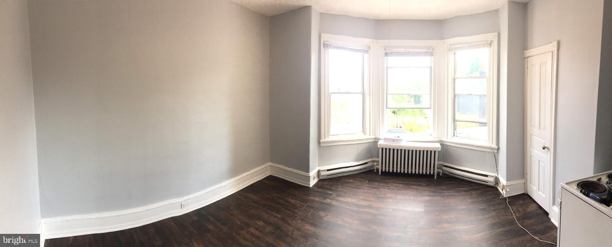 a view of room with window and hardwood floor