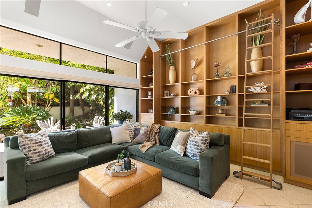 a living room with furniture a rug and a large window