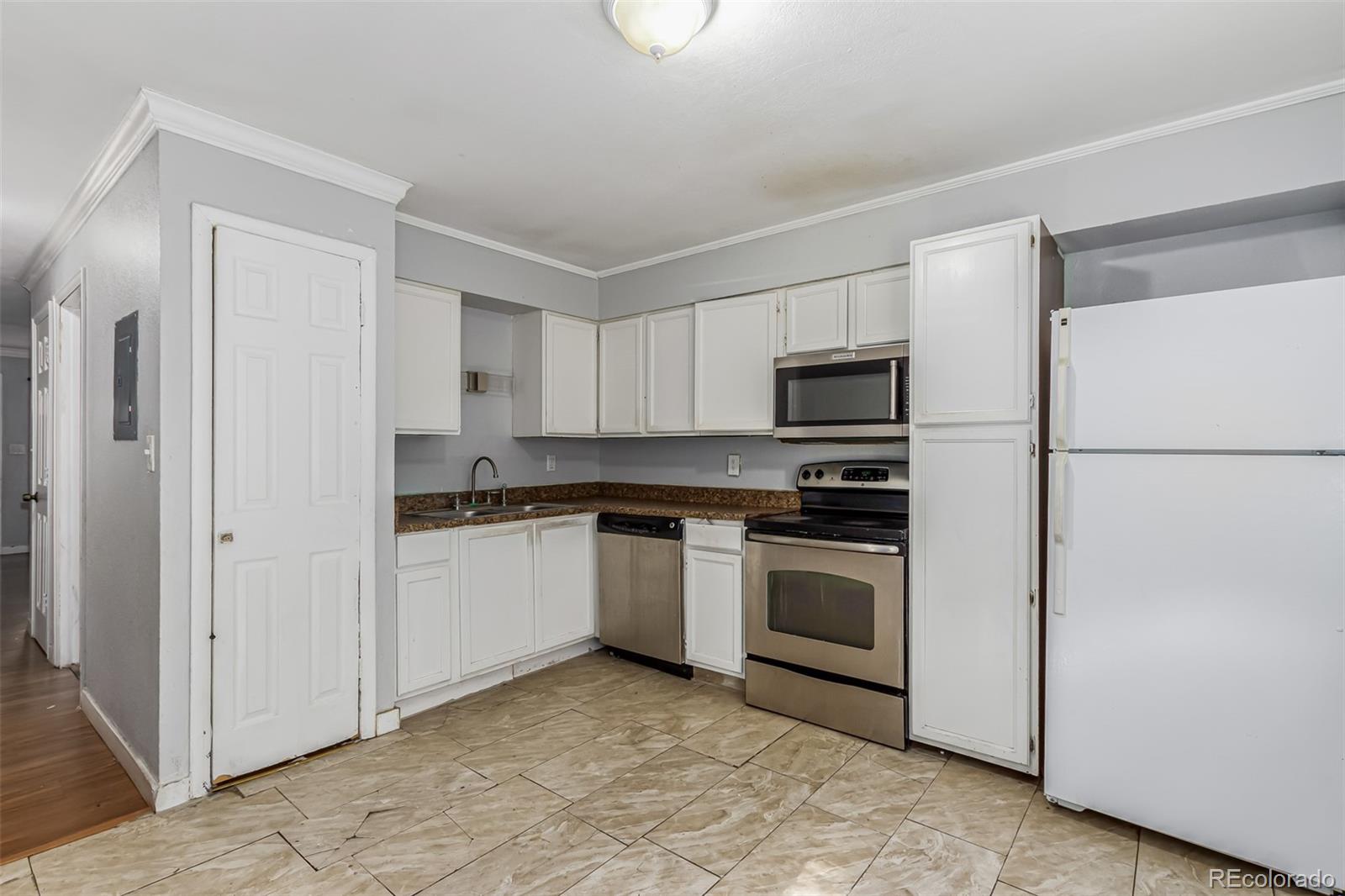 a kitchen with stainless steel appliances granite countertop a refrigerator and a stove top oven