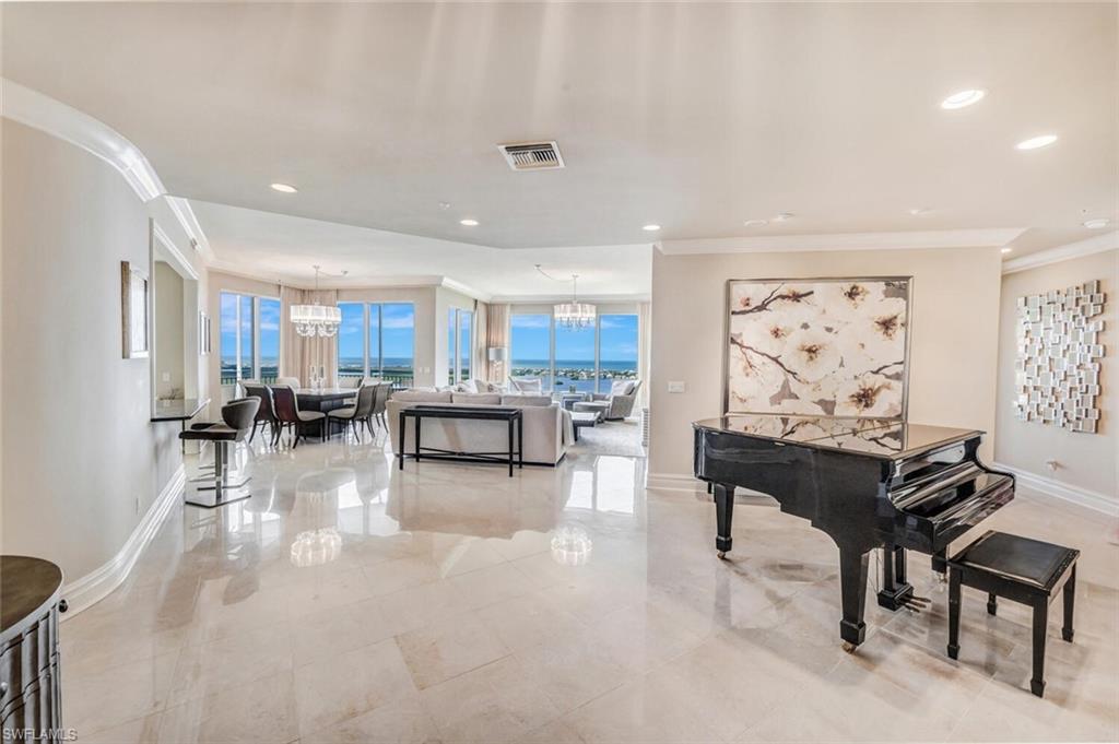 a living room with furniture and kitchen view