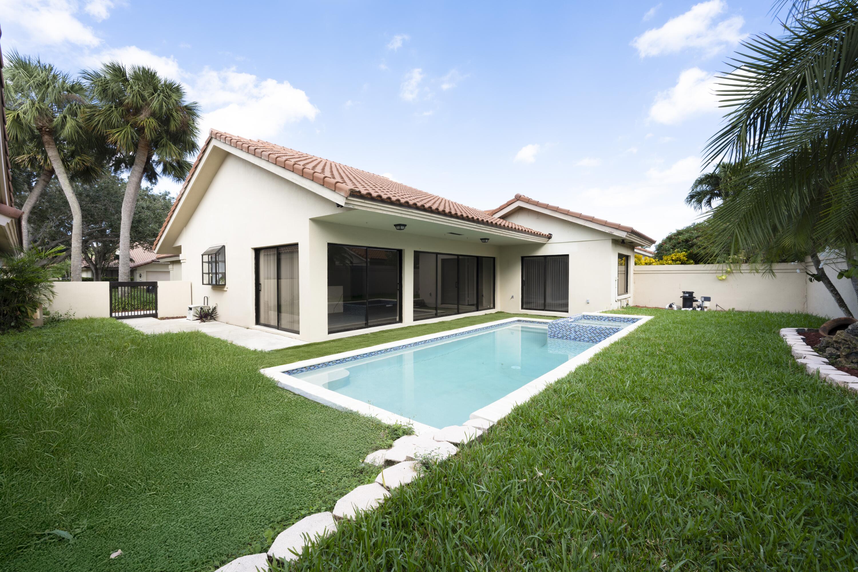 a view of an house with backyard space and balcony