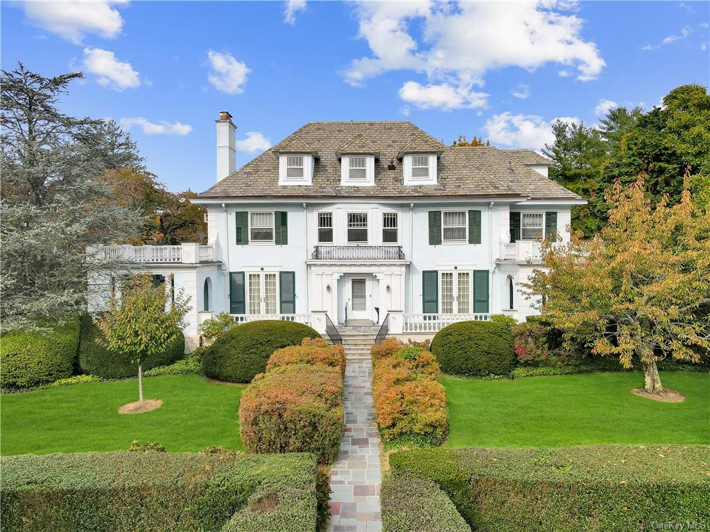 a front view of a house with a garden