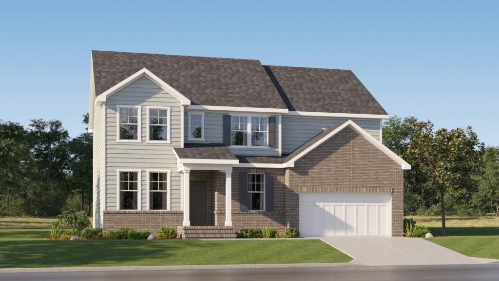 a front view of a house with a yard and trees