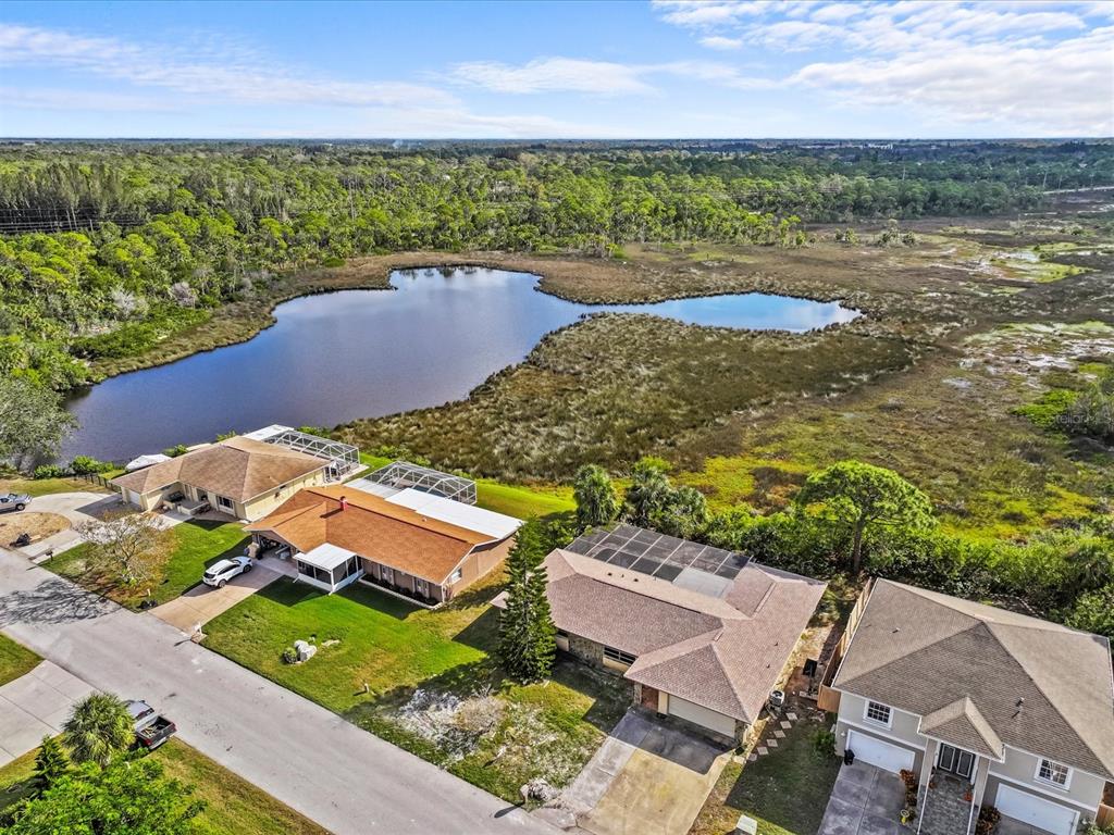 an aerial view of a house with a lake view