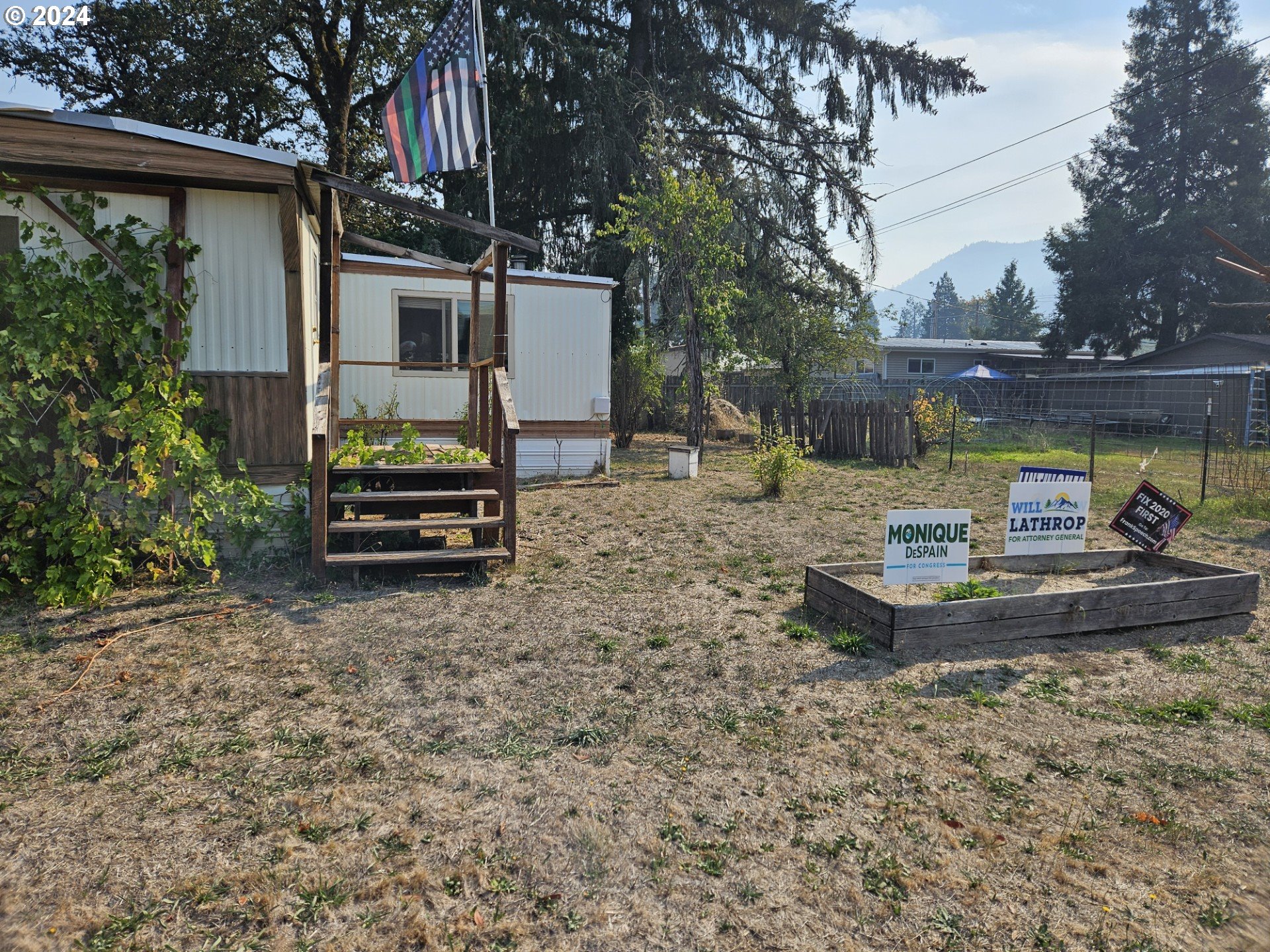 a view of a backyard with sitting area