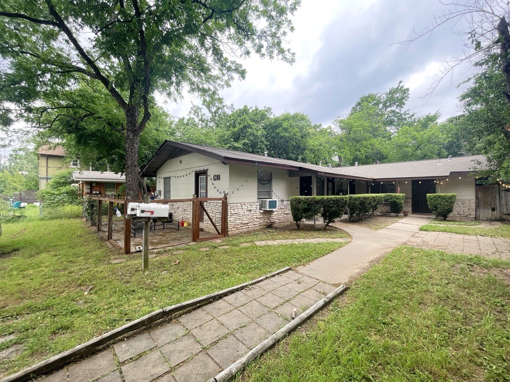 a view of a house with backyard and sitting area