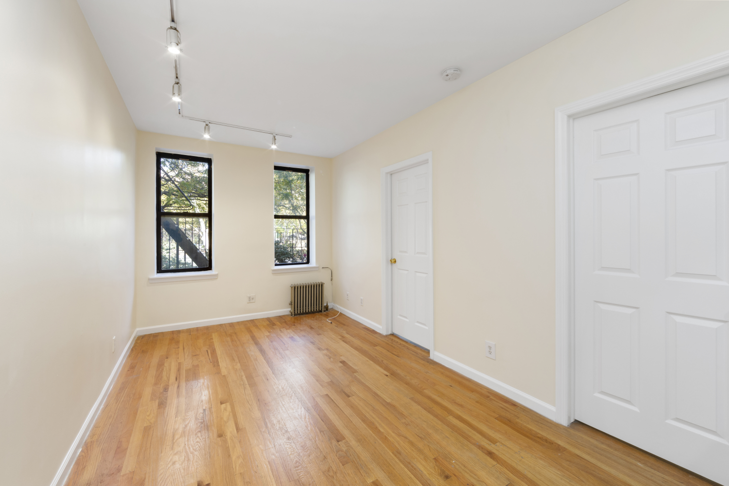 wooden floor in an empty room with a window