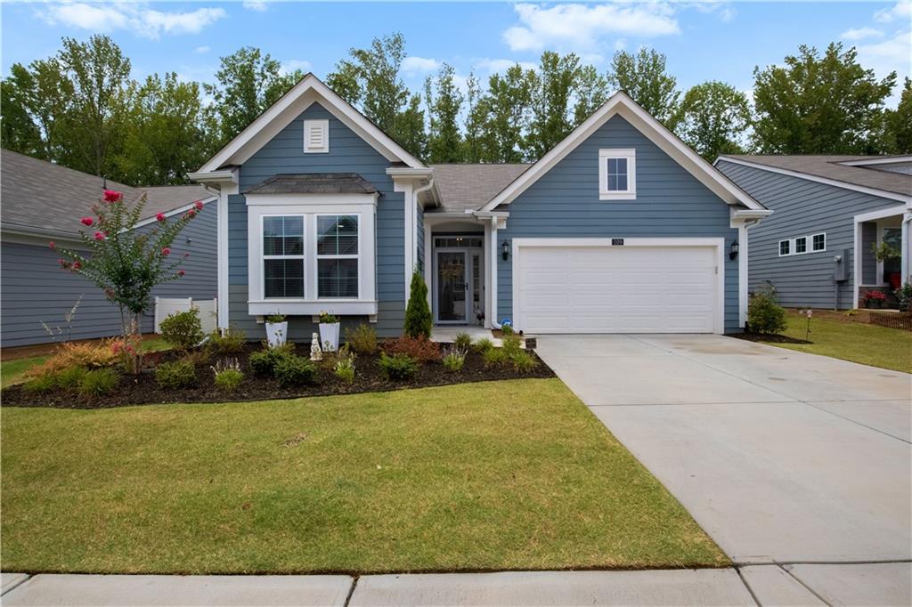 a front view of a house with a yard and garage