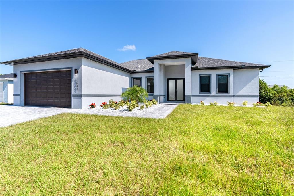 a front view of a house with a yard and garage