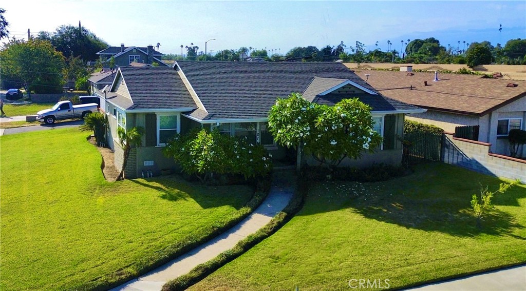 an aerial view of residential houses with outdoor space and swimming pool