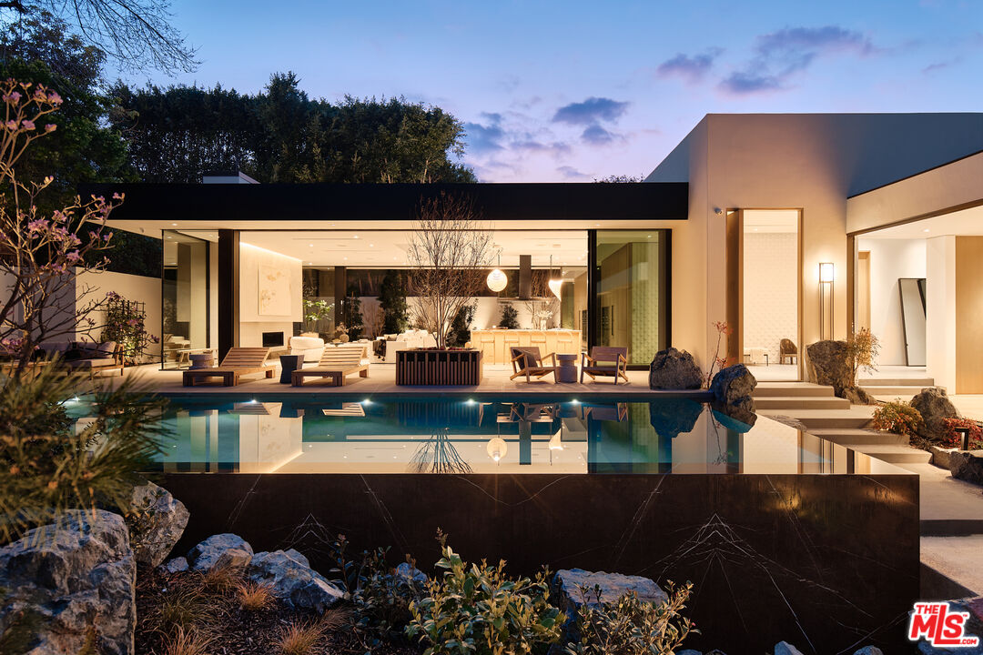 a view of a swimming pool with outdoor seating